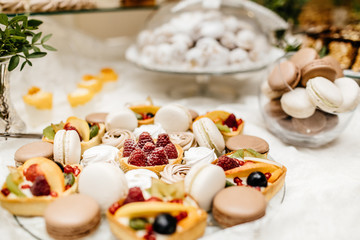 Dessert table for a party. Ombre cake, cupcakes, sweetness and f