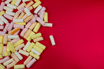 Marshmallows on red background with free space. Food concept