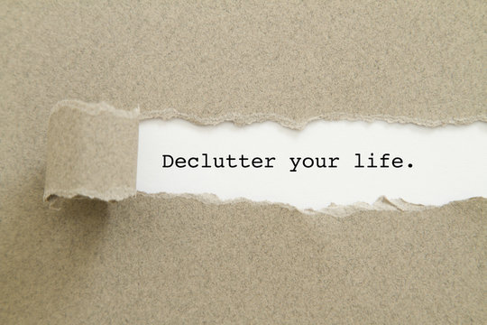 Declutter your life written under torn paper.