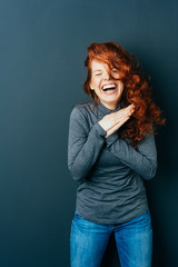 Vivacious redhead woman enjoying a hearty laugh
