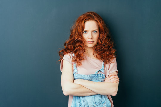 Serious thoughtful young redhead woman