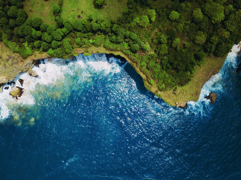 Top view or Aerial view of tropical island forest and emerald clear water of south coast in west sumatera, indonesia.
