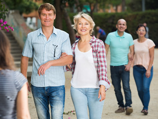 mature males and females walking on holiday