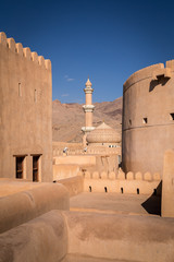 Dome and minaret fo Al Qala'a mosque in Nizwa, Oman, seen from Nizwa Fort.