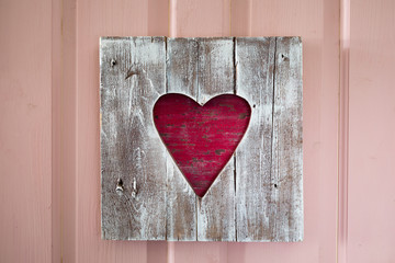 Fototapeta na wymiar St. Valentine handmade wooden heart panel on the door