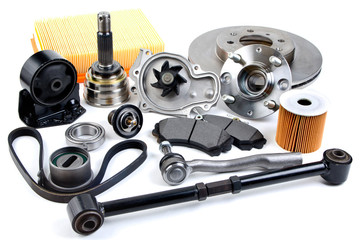 Auto parts background. Hub, pump, brake pads, filter, timing belt, rollers, constant velocity joints, thermostat and other on white background. Set of spare parts for repair