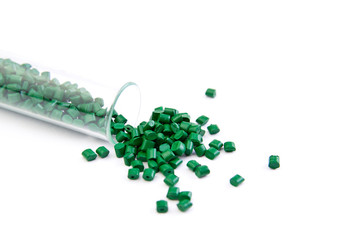 Plastic pallets . Plastic raw materials in granules for industry. Polymeric dye is green on a white...