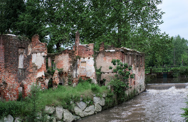 Fototapeta na wymiar ruins of an old brick mill on the river Olona near Milan, Italy