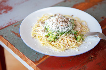 plate with spaghetti and cheese with pine nuts