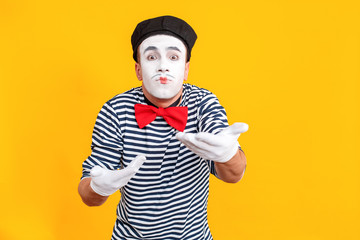 Mime man looking at camera and say take it please