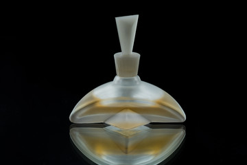 Glass bottle for perfume on a black background