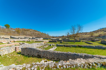 Fototapeta na wymiar Alba Fucens (Italy) - An evocative Roman archaeological site with amphitheater, in a public park in front of Monte Velino mountain with snow, Abruzzo region, central Italy