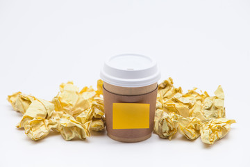 Take away coffee cup with crumpled papers on white background 