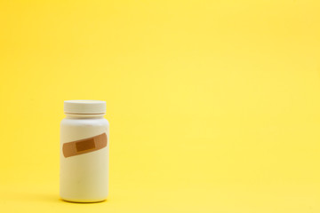 Band with Medicine bottle on the yellow background
