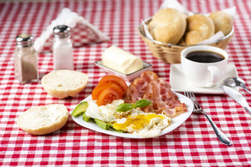 bacon and eggs with avocado and tomato, bread and coffee