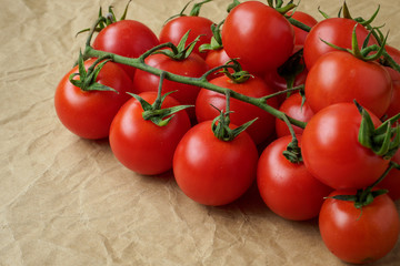 Fresh cherry tomatoes on crumpled paper background