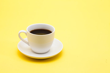 A cup of coffee on a yellow background