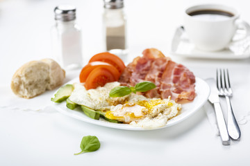 bacon and eggs with avocado and tomato, bread and coffee