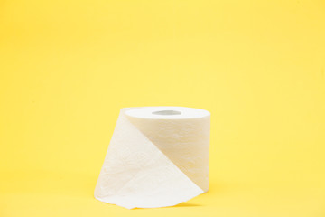 White toilet roll paper on yellow background