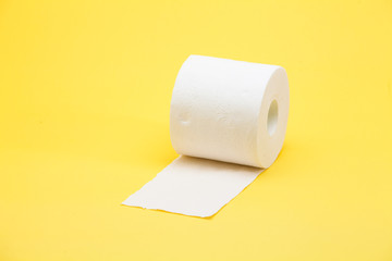 White toilet roll paper on yellow background