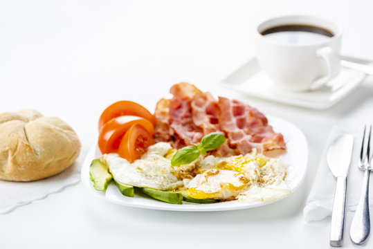bacon and eggs with avocado and tomato, bread and coffee