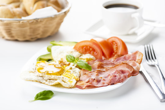 bacon and eggs with avocado and tomato, bread and coffee