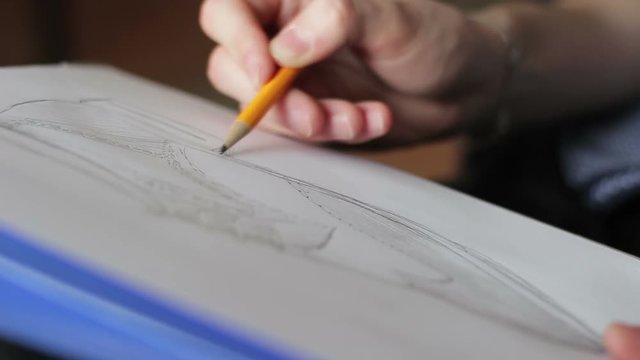fashion designer creating a sketch of the men's shoes model