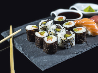 Sushi Set on Slate with Sushi Rolls and Wasabi on Black Background