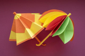 Umbrellas origami paper cut. Two colorful paper umbrellas