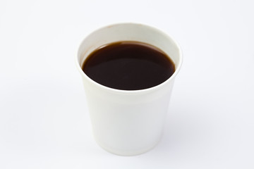 Paper cup of black coffee on white