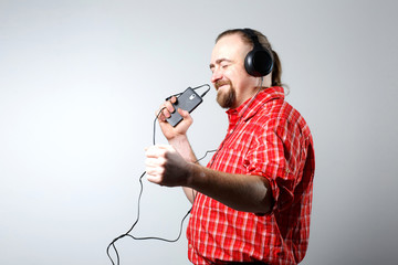 Bearded man in headphones listening to music.