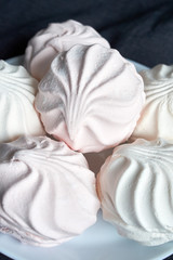 food, confection and sweets concept - close up of zephyr or marshmallow dessert on plate