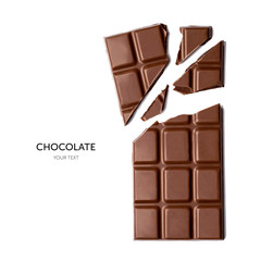 Milk chocolate pieces isolated on white background. Top view