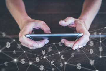 trading currencies on  mobile phone - smartphone with money and bitcoin icons 