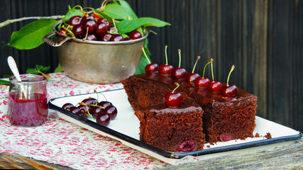 Chocolate cake with cherries and dark chocolate icing, cake with dark beer