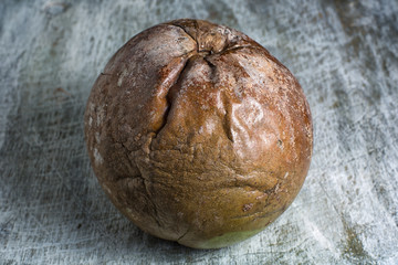 whole borojo fully ripe fruit closeup on wood surface