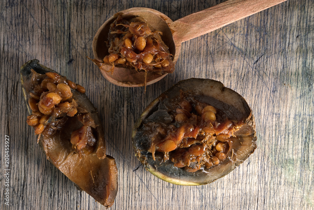 Wall mural borojo fruit, considered a superfood, on rustic wood background