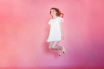 Obraz na płótnie Canvas Happy teenage girl smiling. Closeup portrait young happy positive woman wearing white dress standing on pink colourful pastel trendy modern fashion pin-up background. European woman. Positive human em