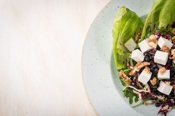 Top view of vegan salad over rustic white table