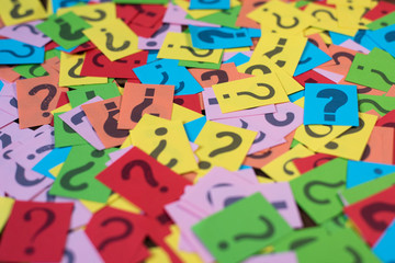 colorful paper with question mark as background. mystery,diversity,questions concept