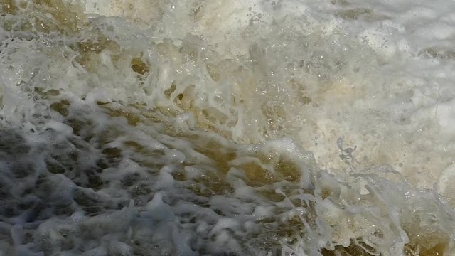 Flood of water floods. Burly and flowing muddy water. Spring flood.