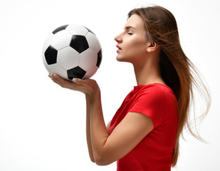 Fan sport woman player in red uniform hold soccer ball celebrating looking at the corner 