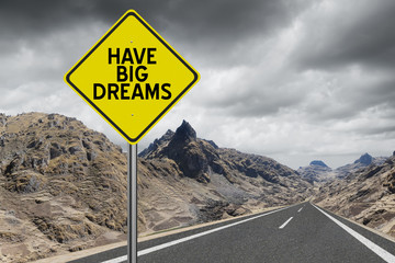 Have Big Dreams highway sign on mountain road background