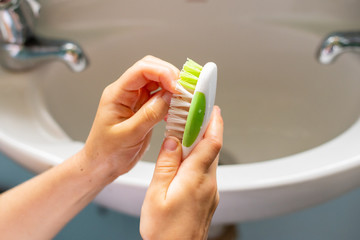 Close up view of little girl scrubbing hands at bathroom sink (selective focus)