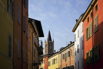 Fototapeta na wymiar Narrow colourful alley on a sunny Winter day, Parma, Italy