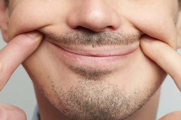 Forced fake smile close up