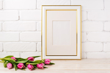 Gold decorated frame mockup with magenta tulips bouquet