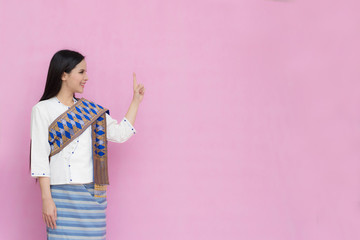 Portrait beautiful Asian girl in traditional Thai dress isolated on pink background. .Cotton Dress