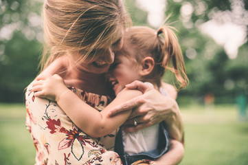 Mother hugging daugher