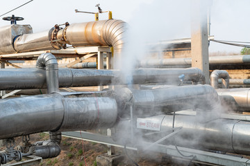 Leakage of steam in heat pipeline interior industrial gas with a lot of piping. Steam valve piping...